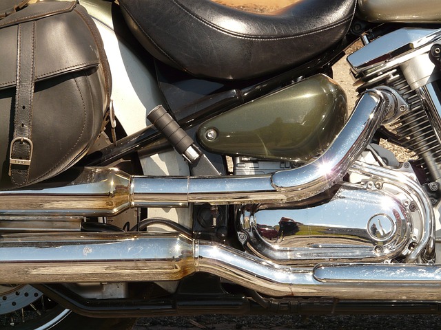 Head view of a red and chrome motorcycle with its exhaust pipes glowing a bright orange
