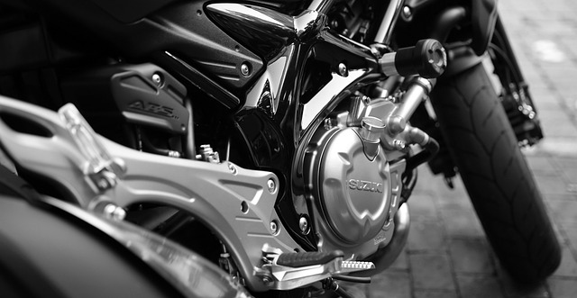 -up of a person polishing a motorcycle with a cloth, showing every meticulous detail on the vehicle's body and chrome